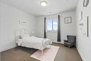 Carpeted bedroom with baseboards