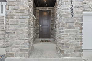 Property entrance featuring stone siding