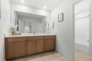 Full bathroom featuring vanity, recessed lighting, tub / shower combination, and light tile patterned flooring