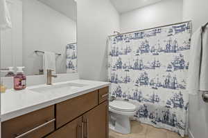 Full bath featuring vanity and shower / bath combo with shower curtain