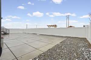 Fenced backyard with a patio