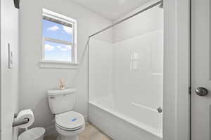 Bathroom featuring toilet and  shower combination