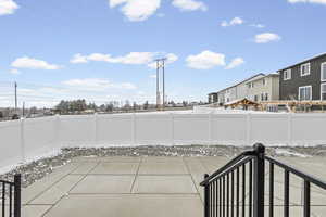 Fenced backyard featuring a patio area and a residential view
