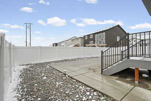 Fenced backyard with a patio area and a residential view