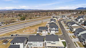 Aerial view of property's location featuring nearby suburban area and a mountainous background