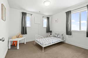 Carpeted bedroom with baseboards