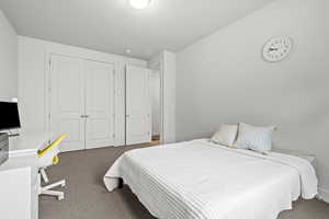 Carpeted bedroom featuring a closet