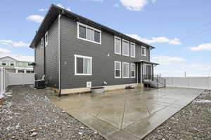 Back of property featuring a fenced backyard and a patio area