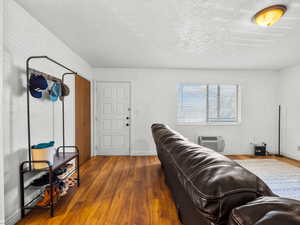 Living room featuring wood finished floors and a textured ceiling