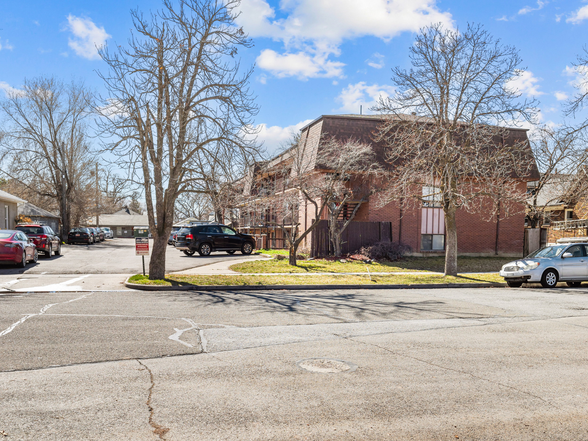 View of asphalt street featuring sidewalks and curbs