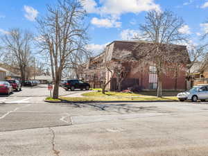 View of asphalt street featuring sidewalks and curbs