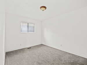 Spare room with carpet floors and baseboards