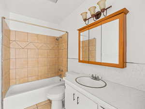 Full bath featuring vanity, bathing tub / shower combination, and light tile patterned floors