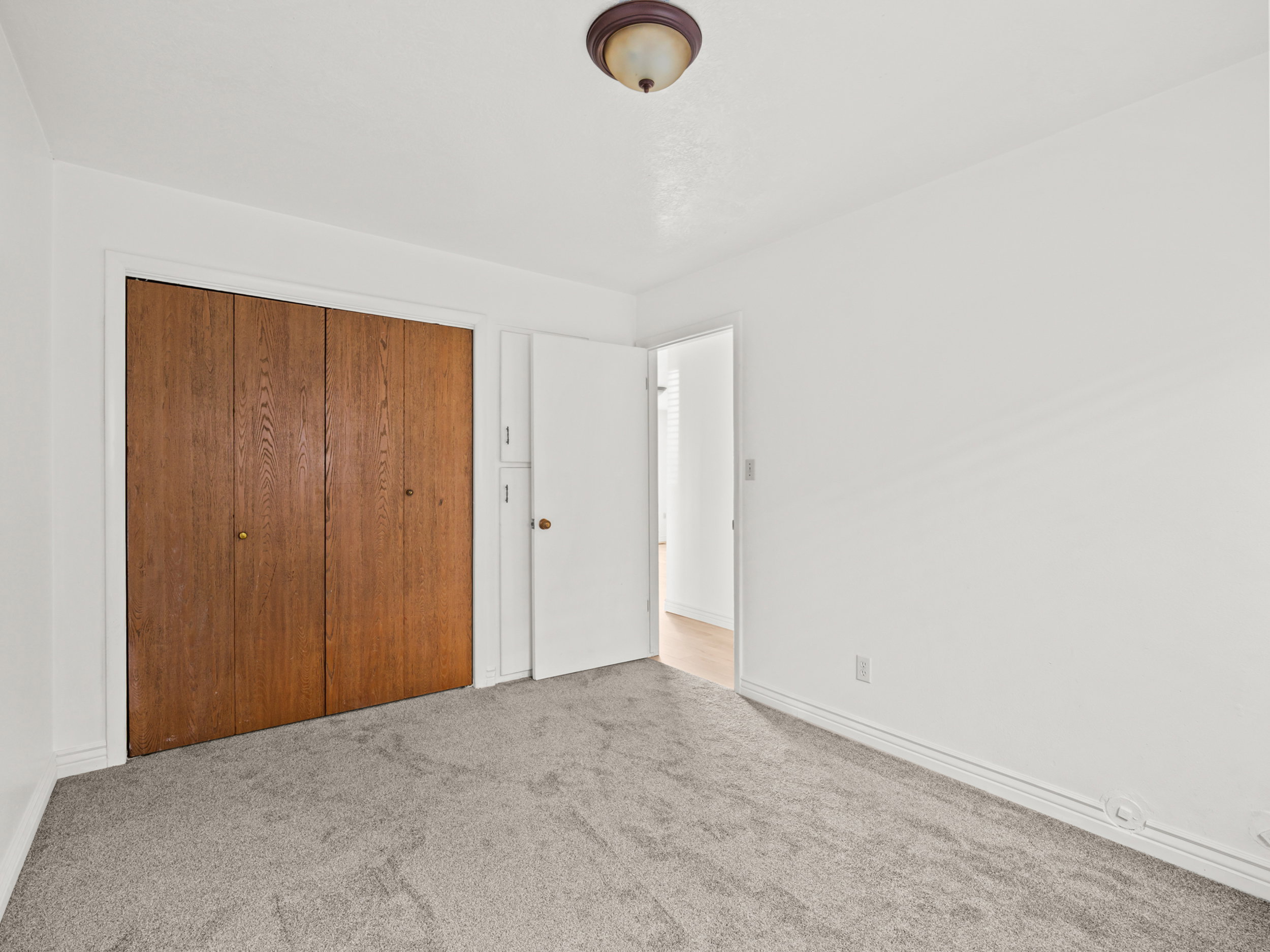 Unfurnished bedroom featuring carpet floors and a closet