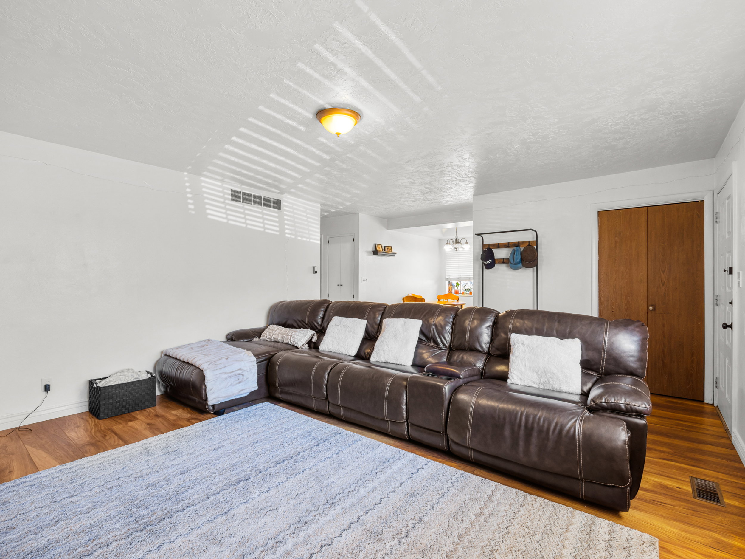 Living room featuring wood finished floors and a textured ceiling