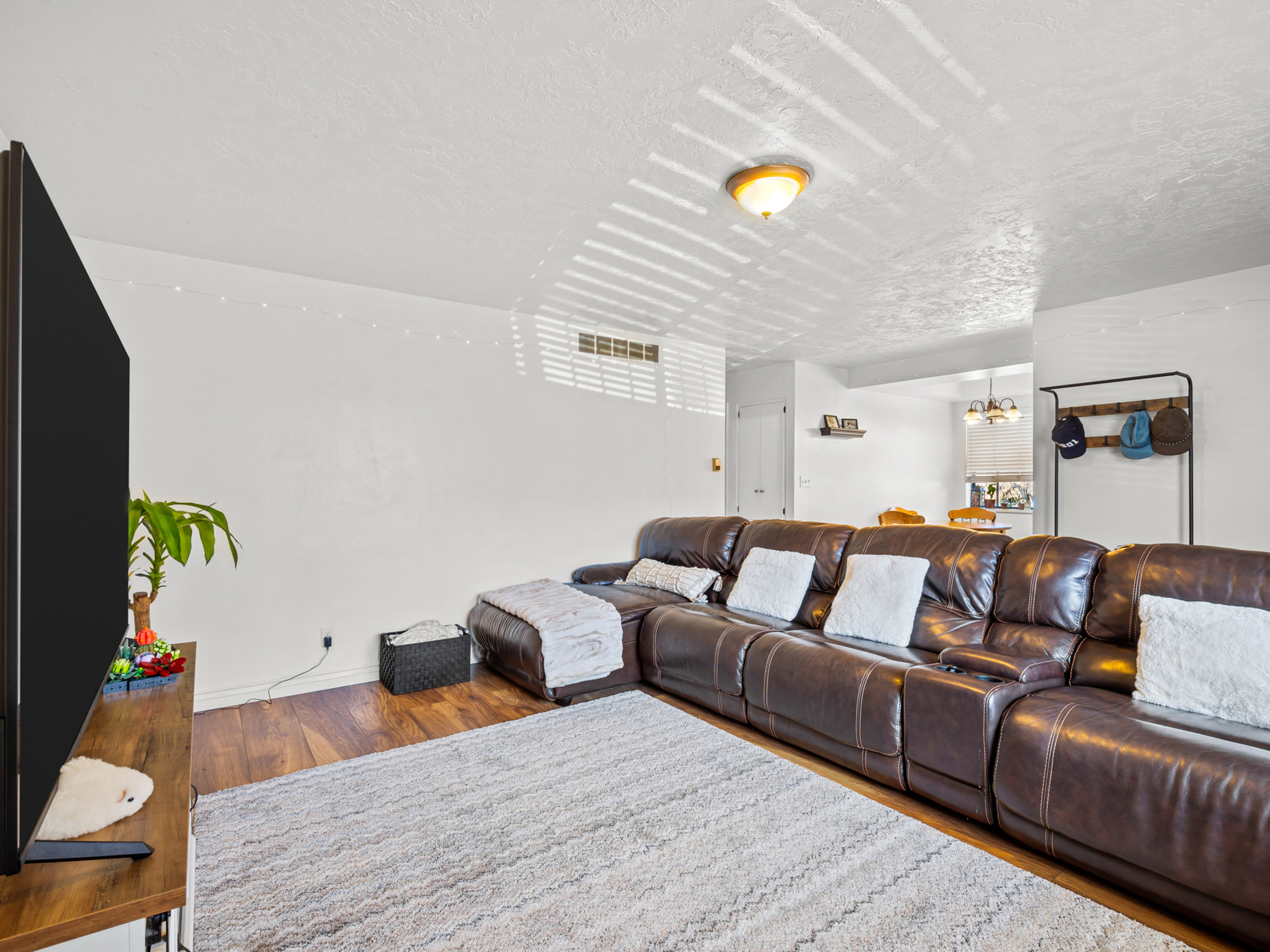 Living room featuring wood finished floors and a textured ceiling