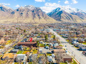 Aerial view of property's location with mountains and nearby suburban area