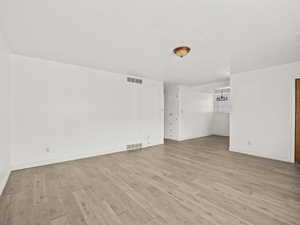 Unfurnished room with light wood-style flooring
