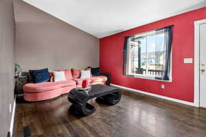 Living area featuring wood finished floors and vaulted ceiling