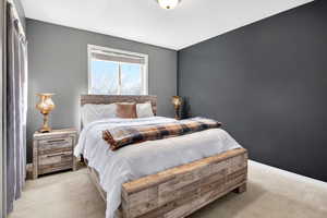 Bedroom featuring light colored carpet and baseboards