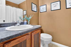 Full bathroom with vanity, a shower with curtain, and light tile patterned floors