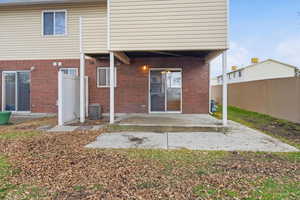 Back of house featuring a patio and brick siding