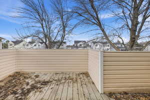 Wooden terrace featuring a residential view