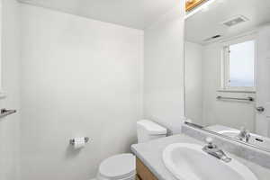 Half bath with vanity and toilet