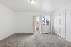 Unfurnished bedroom featuring carpet and a closet