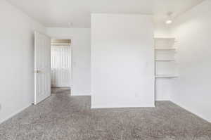 Unfurnished bedroom featuring light colored carpet and baseboards