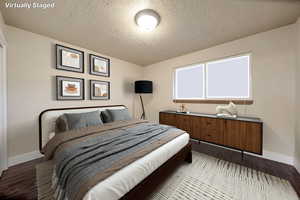 Bedroom featuring a textured ceiling and light wood-style flooring