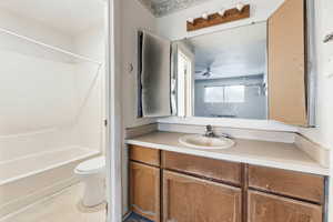Full bath with vanity, light flooring, and washtub / shower combination
