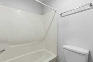 Full bath with toilet and shower / bath combination