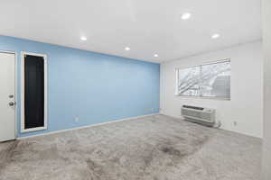 Unfurnished room with light carpet and recessed lighting