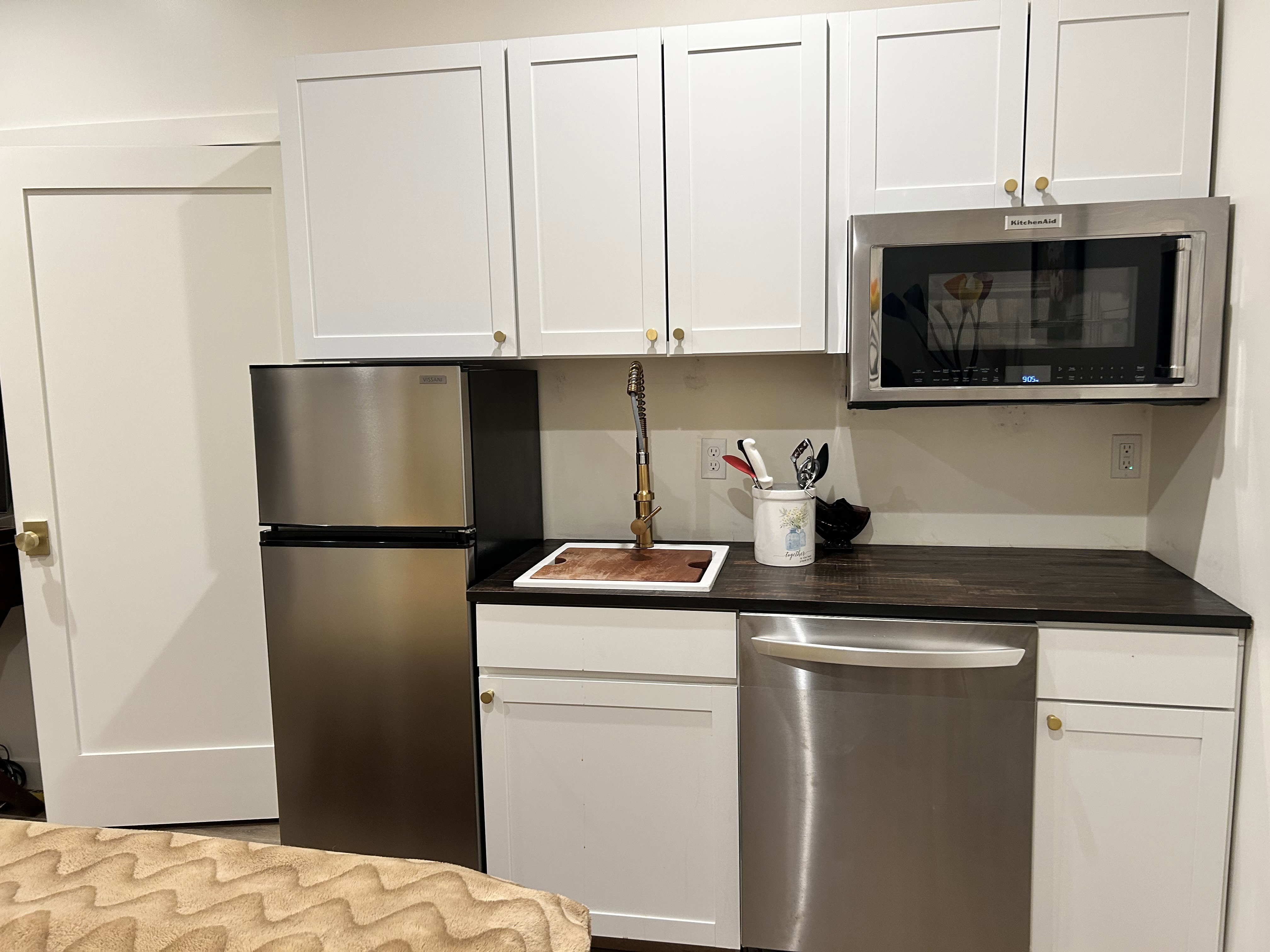 Kitchen with stainless steel appliances and white cabinets