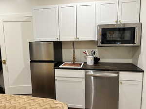 Kitchen with stainless steel appliances and white cabinets