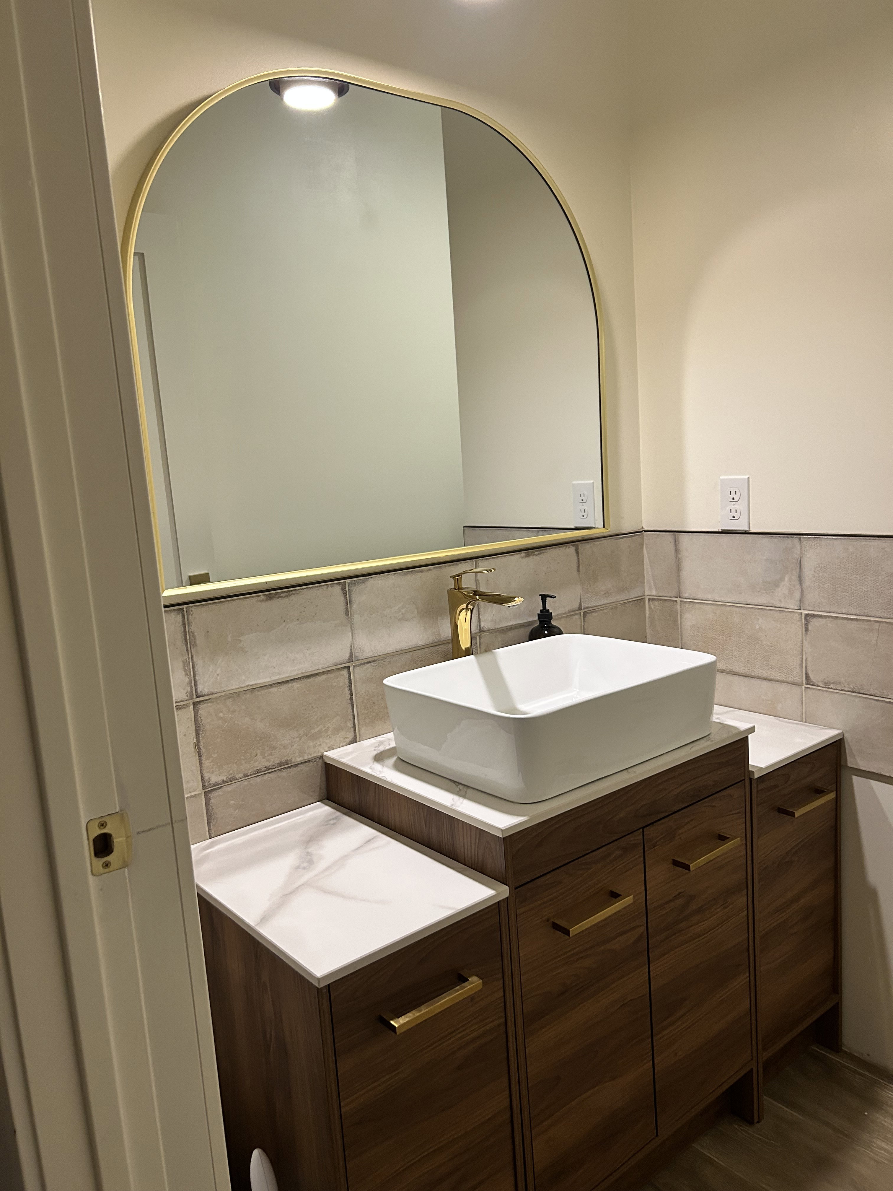 Bathroom with vanity and tile walls