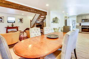 Dining space featuring recessed lighting, light wood-style floors, and beam ceiling