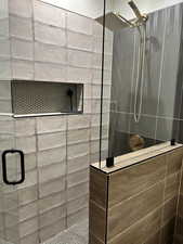 Full bathroom featuring a tile shower