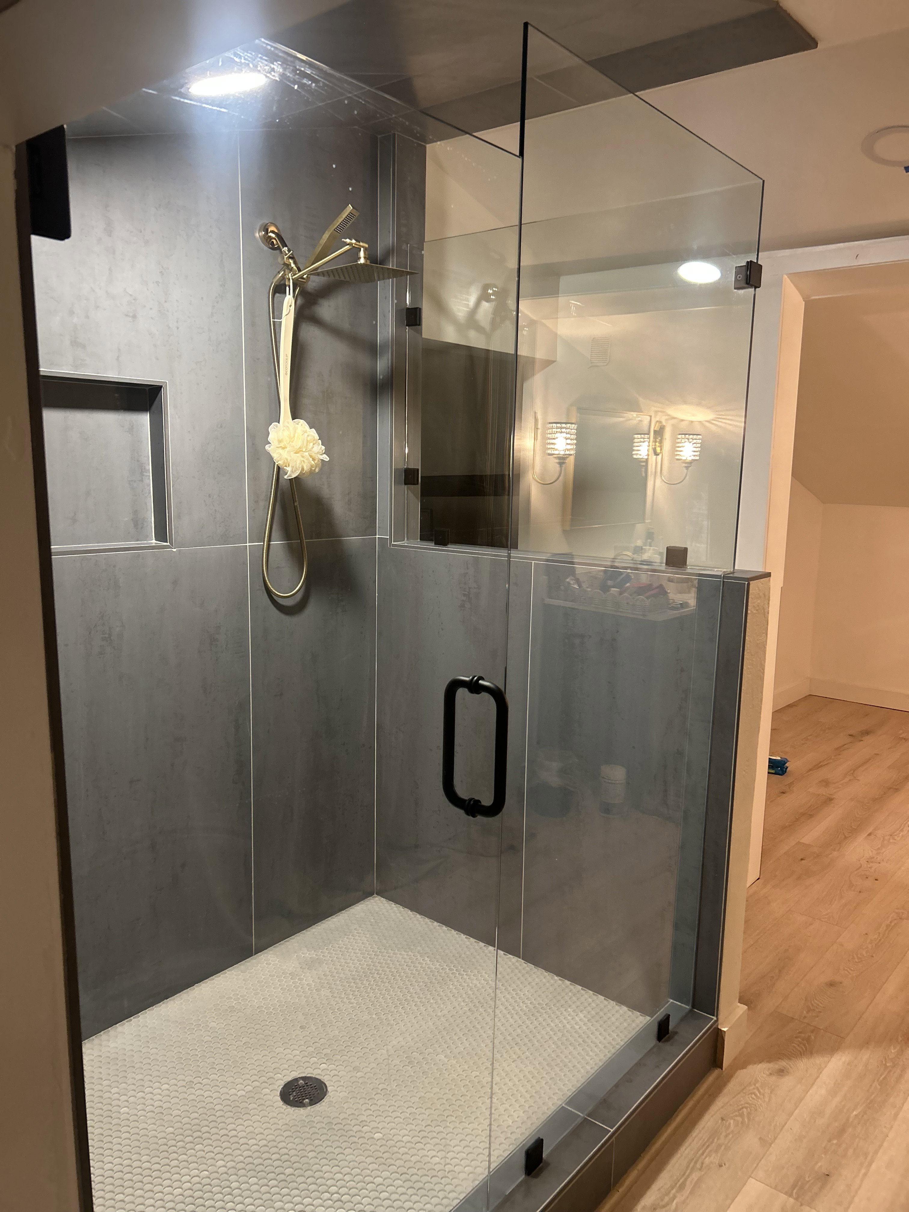 Bathroom with wood finished floors and a shower stall