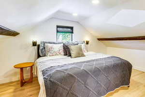 Bedroom with baseboards and light wood finished floors