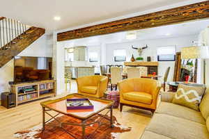 Living area featuring light wood finished floors and recessed lighting