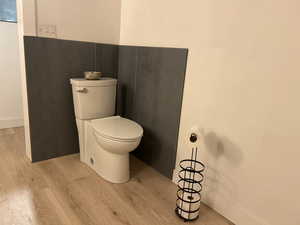Bathroom featuring light wood-style flooring and toilet