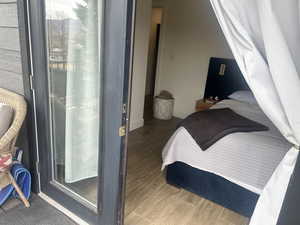 Bedroom featuring wood finished floors and baseboards