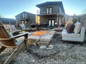 Rear view of house with french doors, a patio area, and an outdoor fire pit