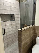 Bathroom with a stall shower and tile walls