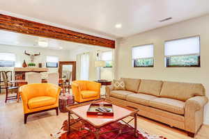 Living area featuring light wood-style flooring and recessed lighting
