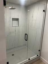 Bathroom with a marble finish shower