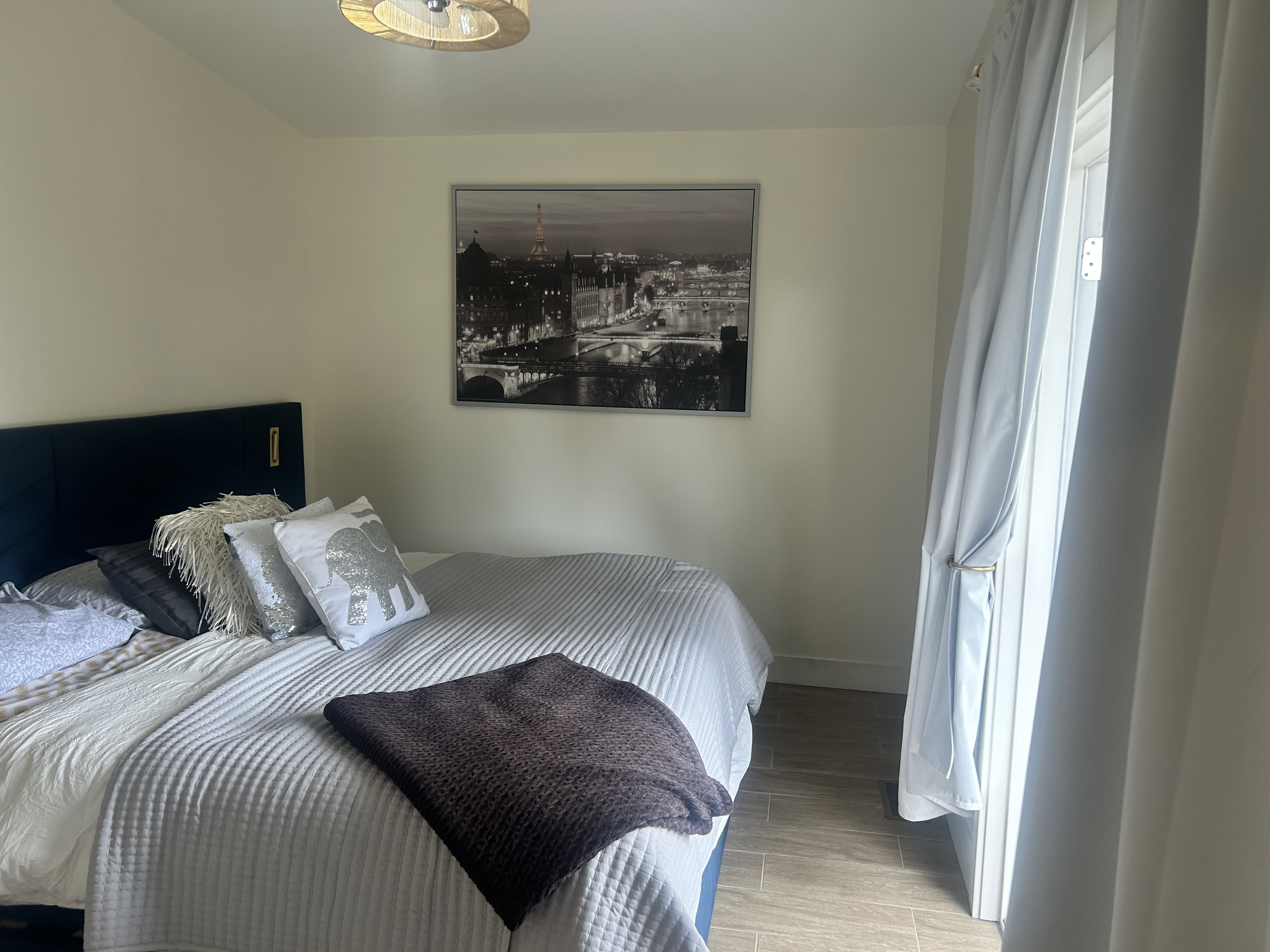 Bedroom with wood finish floors and baseboards