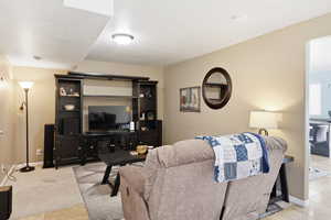 Living room featuring light tile patterned floors and baseboards